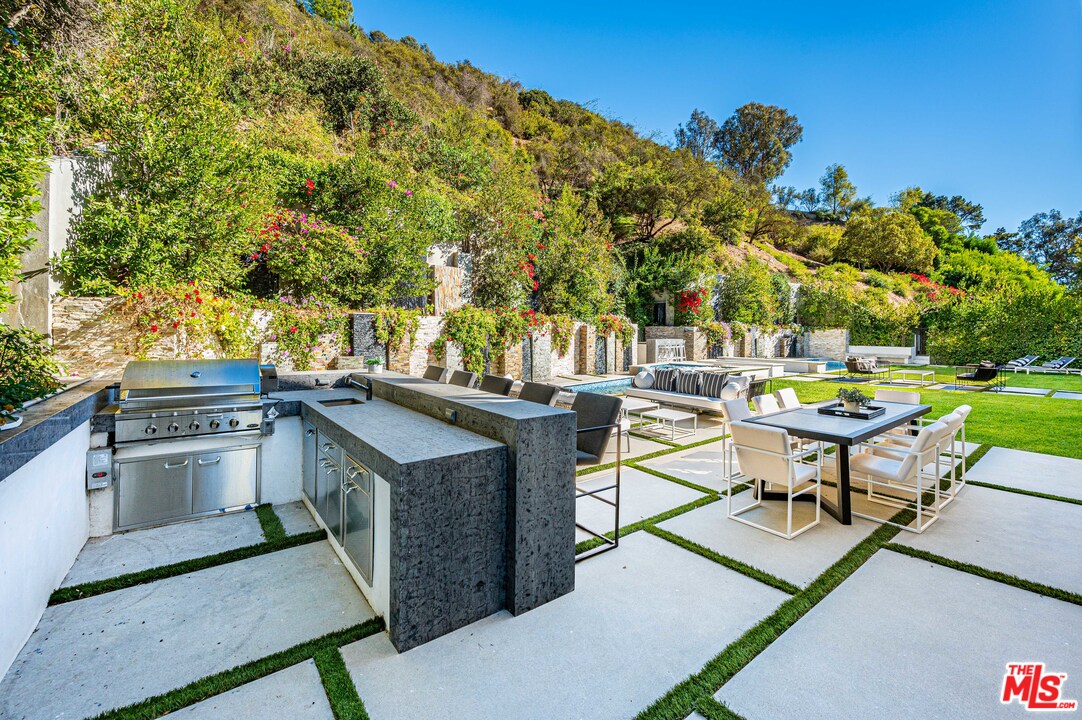 930 Roscomare Road Los Angeles, CA 90077 - Photo 8 of 54 a view of a patio with chairs and a table