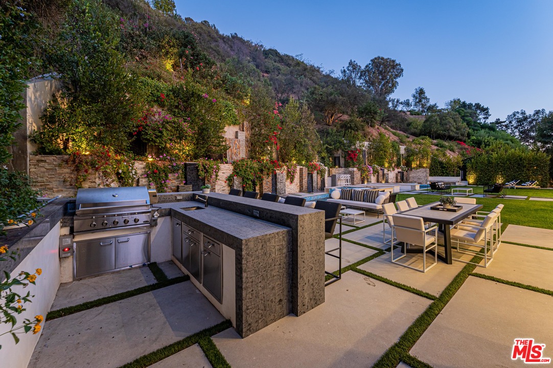 930 Roscomare Road Los Angeles, CA 90077 - Photo 9 of 54 a view of a patio with chairs and a table