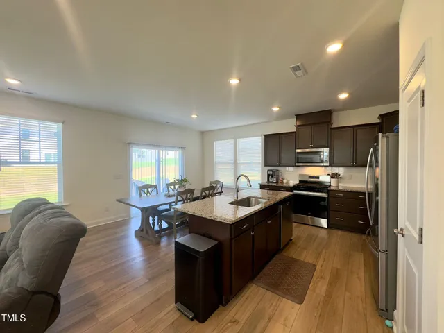 a kitchen with counter top space a sink appliances and cabinets