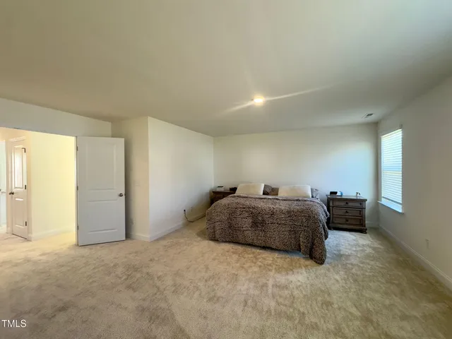 a bedroom with a bed and dresser