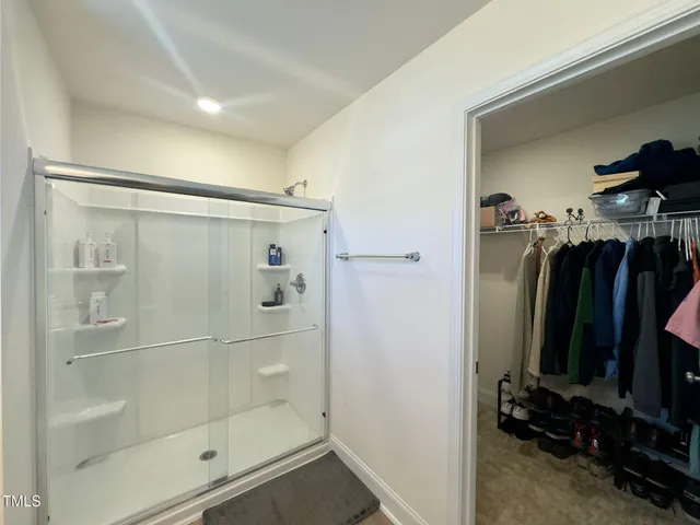 a bathroom with a shower and a mirror