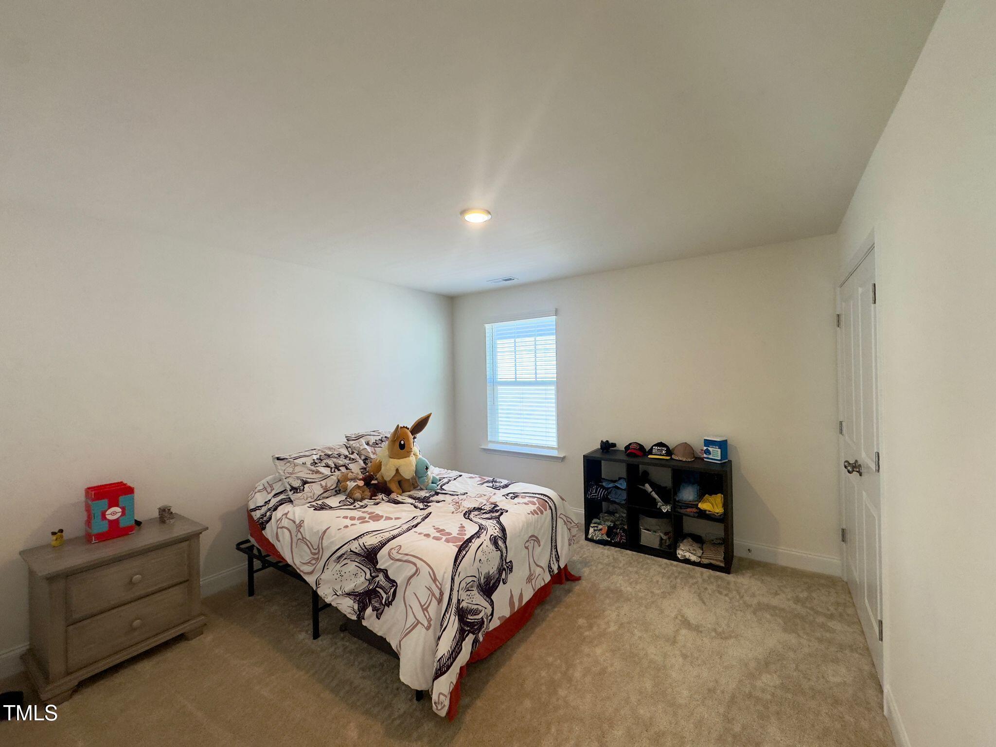 47 Flowing River Road Angier, NC 27501 - Photo 30 of 38 a bedroom with a bed and window