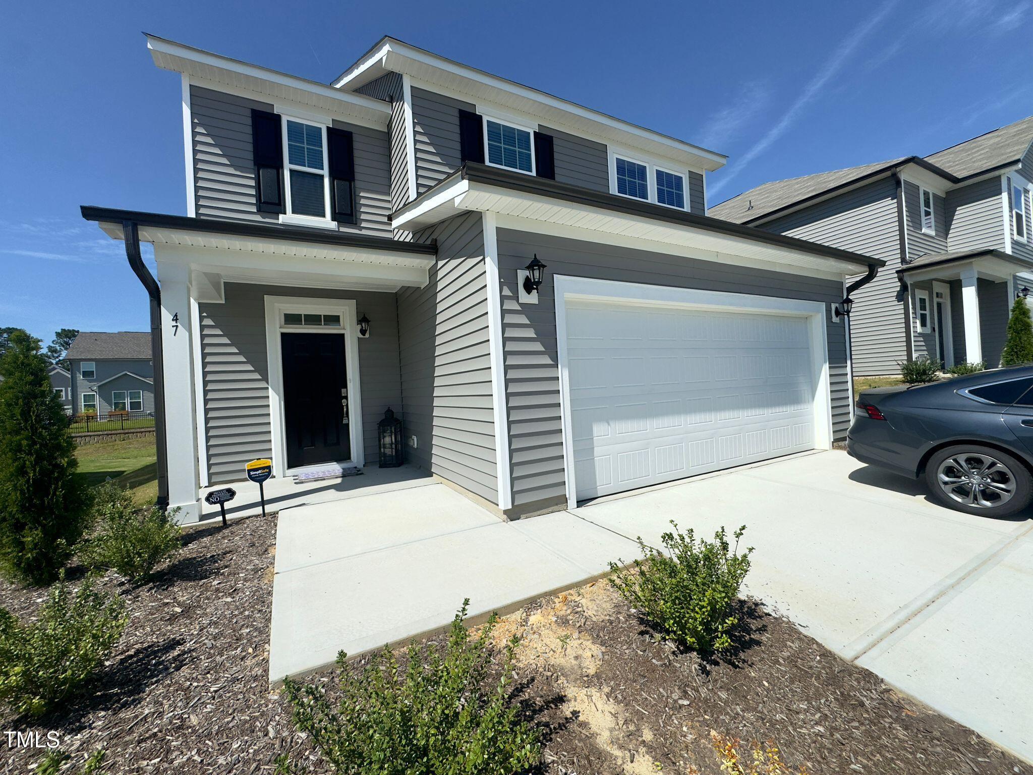 47 Flowing River Road Angier, NC 27501 - Photo 3 of 38 a front view of a house with a yard and garage