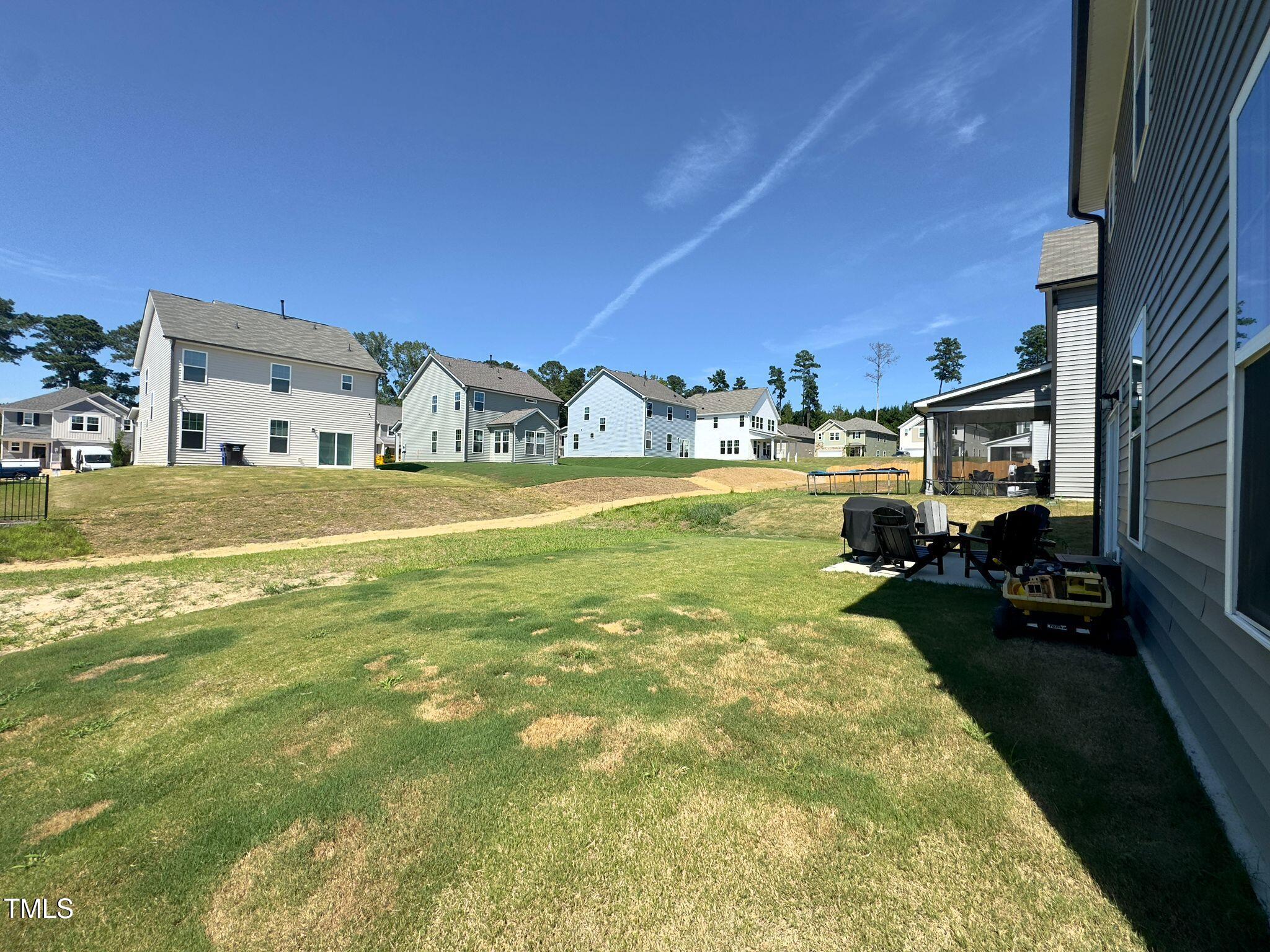 47 Flowing River Road Angier, NC 27501 - Photo 35 of 38 a view of a house with a big yard and potted plants