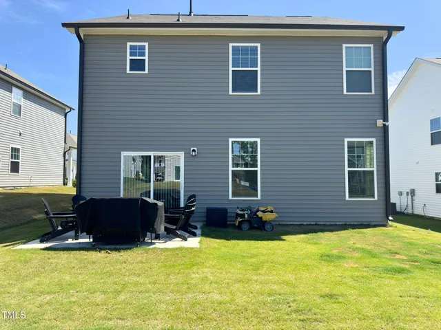 a swimming pool with outdoor seating yard and glass windows