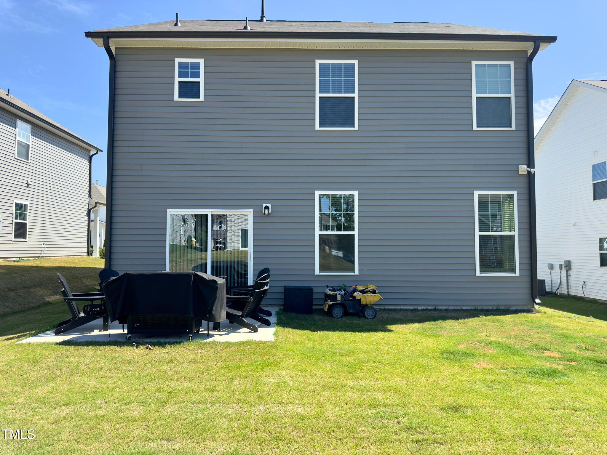47 Flowing River Road Angier, NC 27501 - Photo 36 of 38 a swimming pool with outdoor seating yard and glass windows