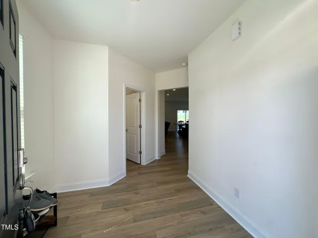 a view of a room with wooden floor