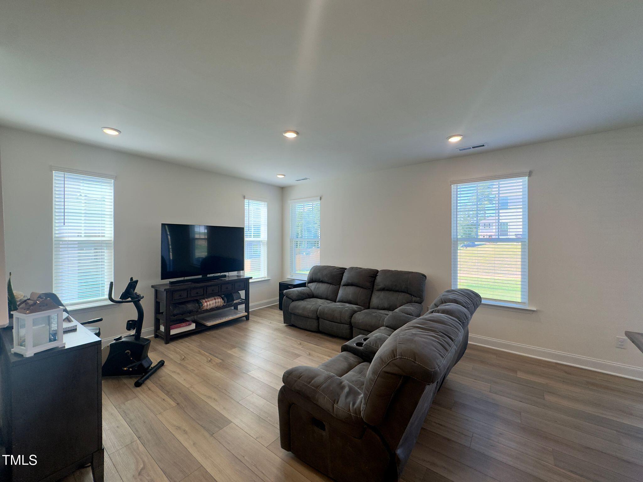 47 Flowing River Road Angier, NC 27501 - Photo 9 of 38 a living room with furniture and a flat screen tv