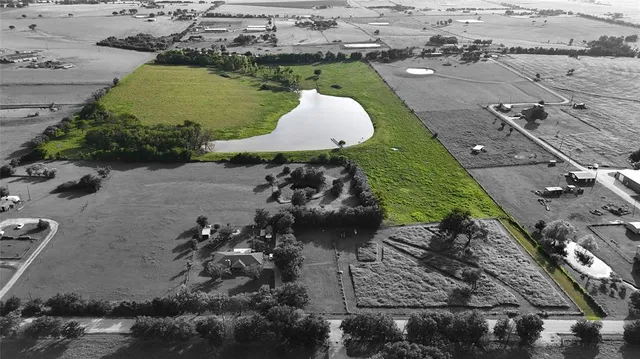 an aerial view of a house with a yard basket ball court and outdoor seating