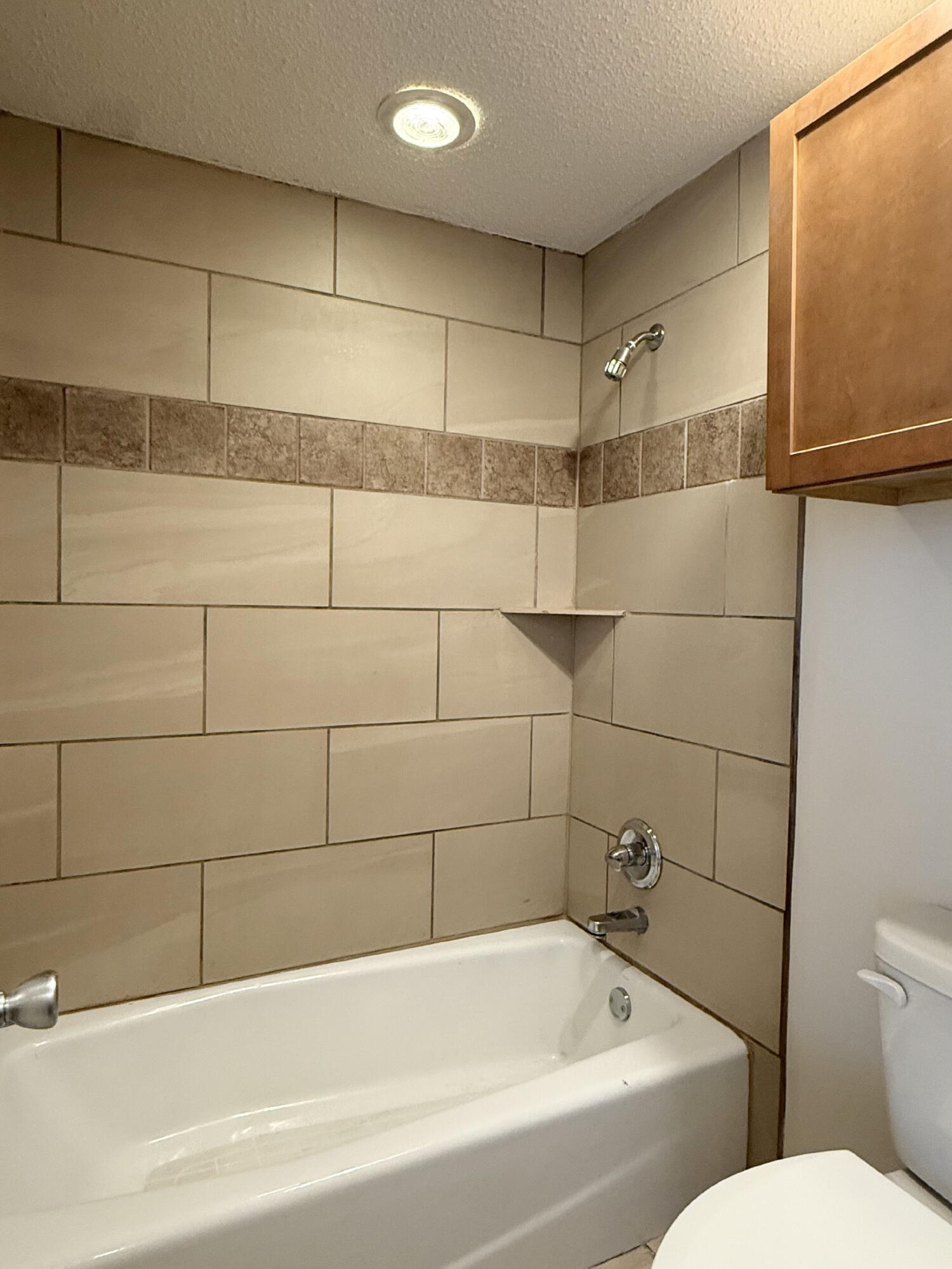 3607 Gary Avenue Lubbock, TX 79413 - Photo 11 of 26 a bathroom with a bathtub and toilet