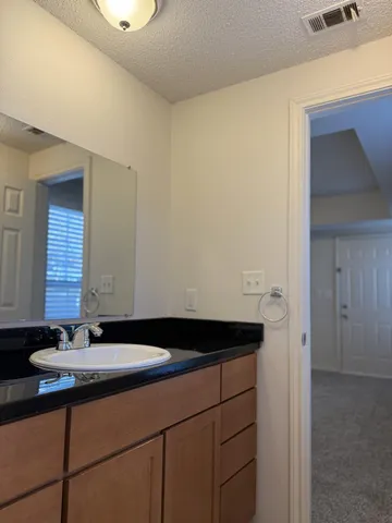 an empty room with closet and fire place