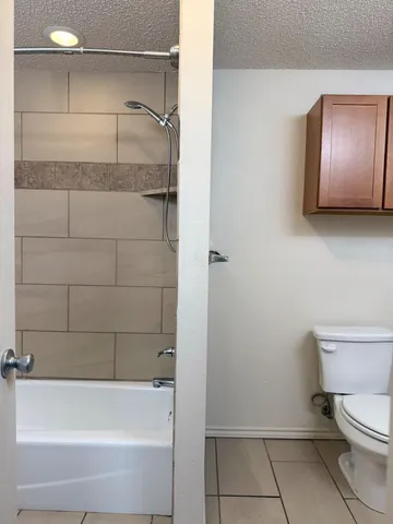 an empty room with closet and a bathroom