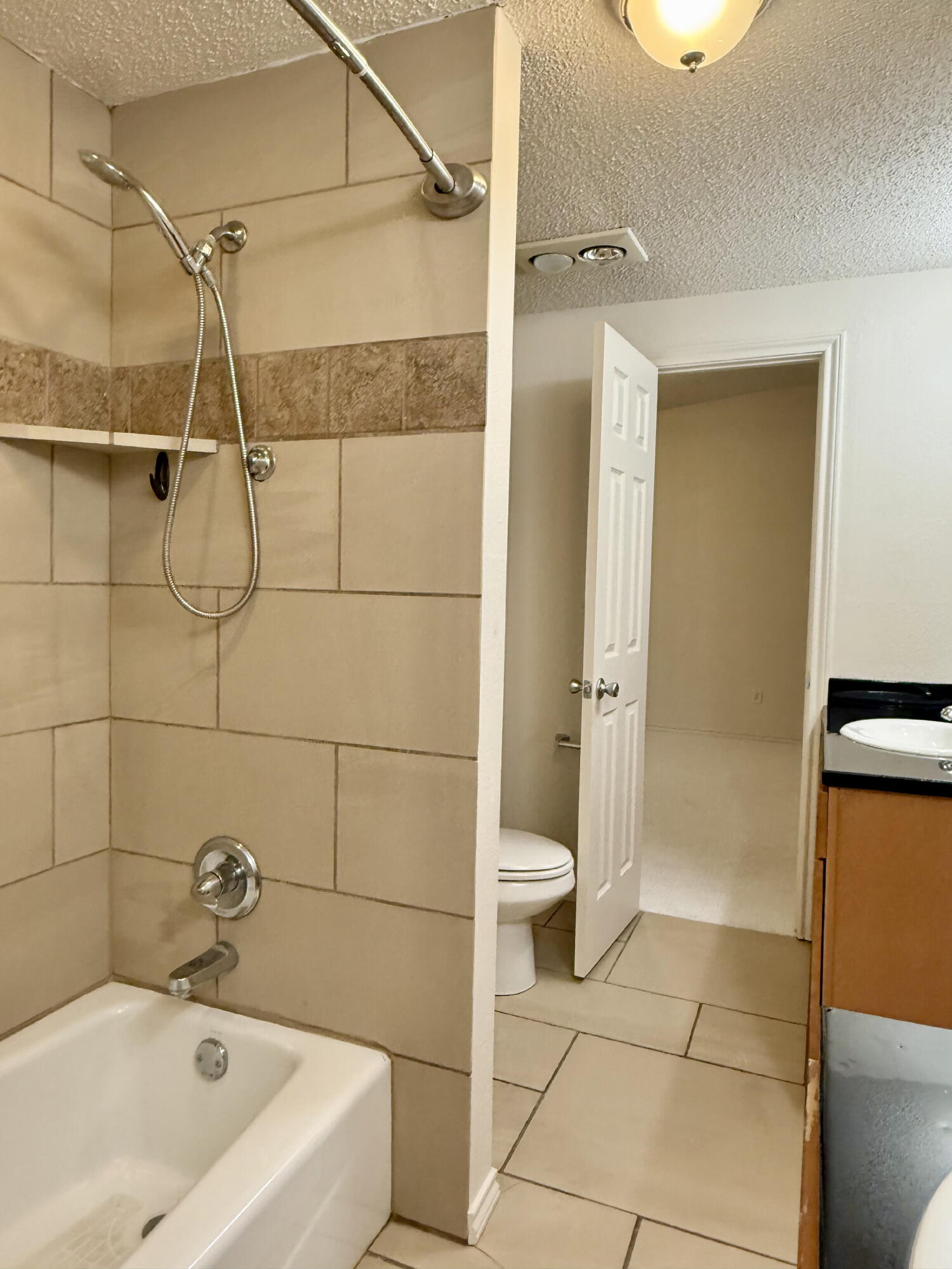 3607 Gary Avenue Lubbock, TX 79413 - Photo 19 of 26 a bathroom with a bathtub and a shower