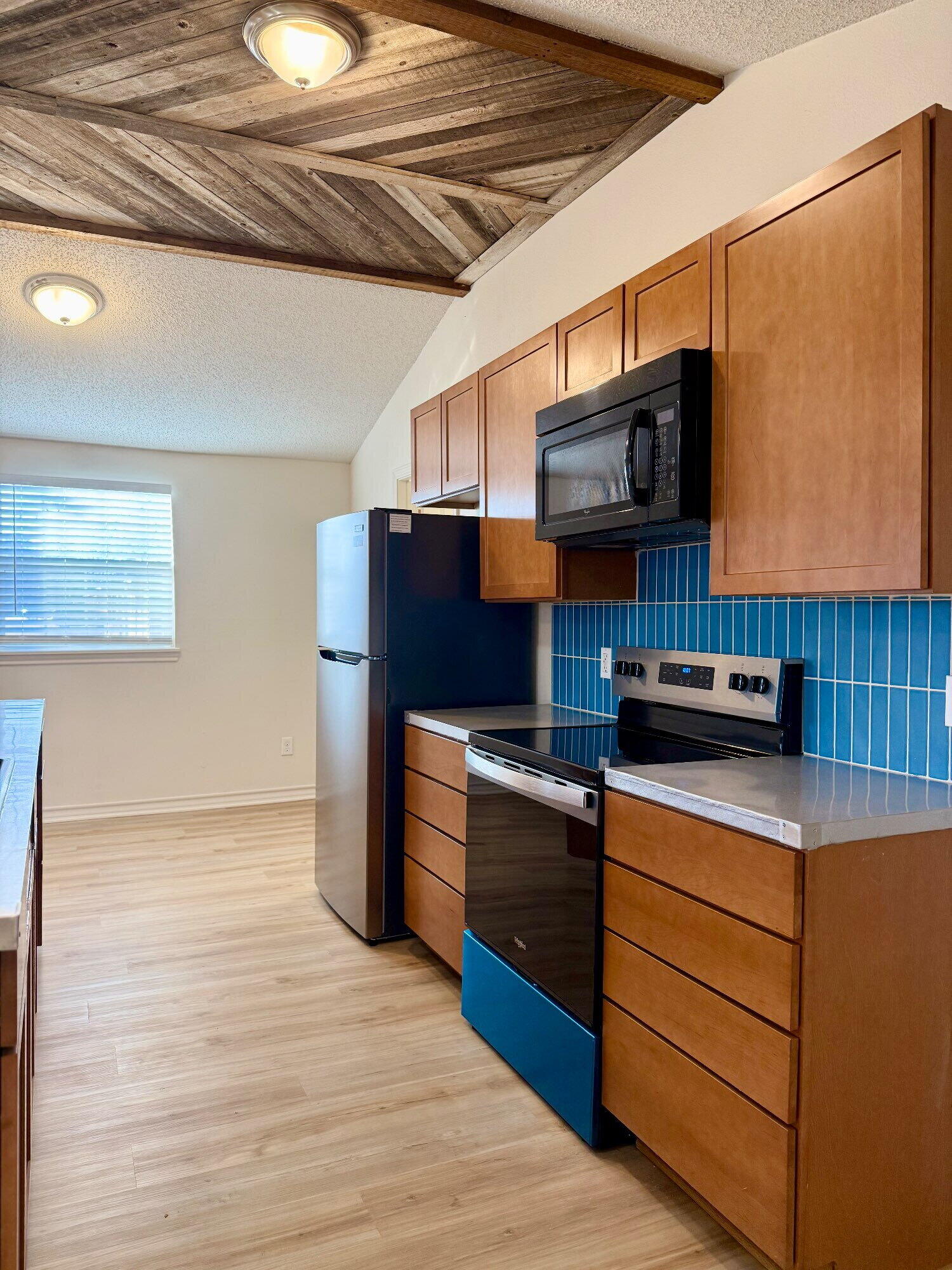 3607 Gary Avenue Lubbock, TX 79413 - Photo 6 of 26 a kitchen with kitchen island granite countertop wooden cabinets and a stainless steel appliances