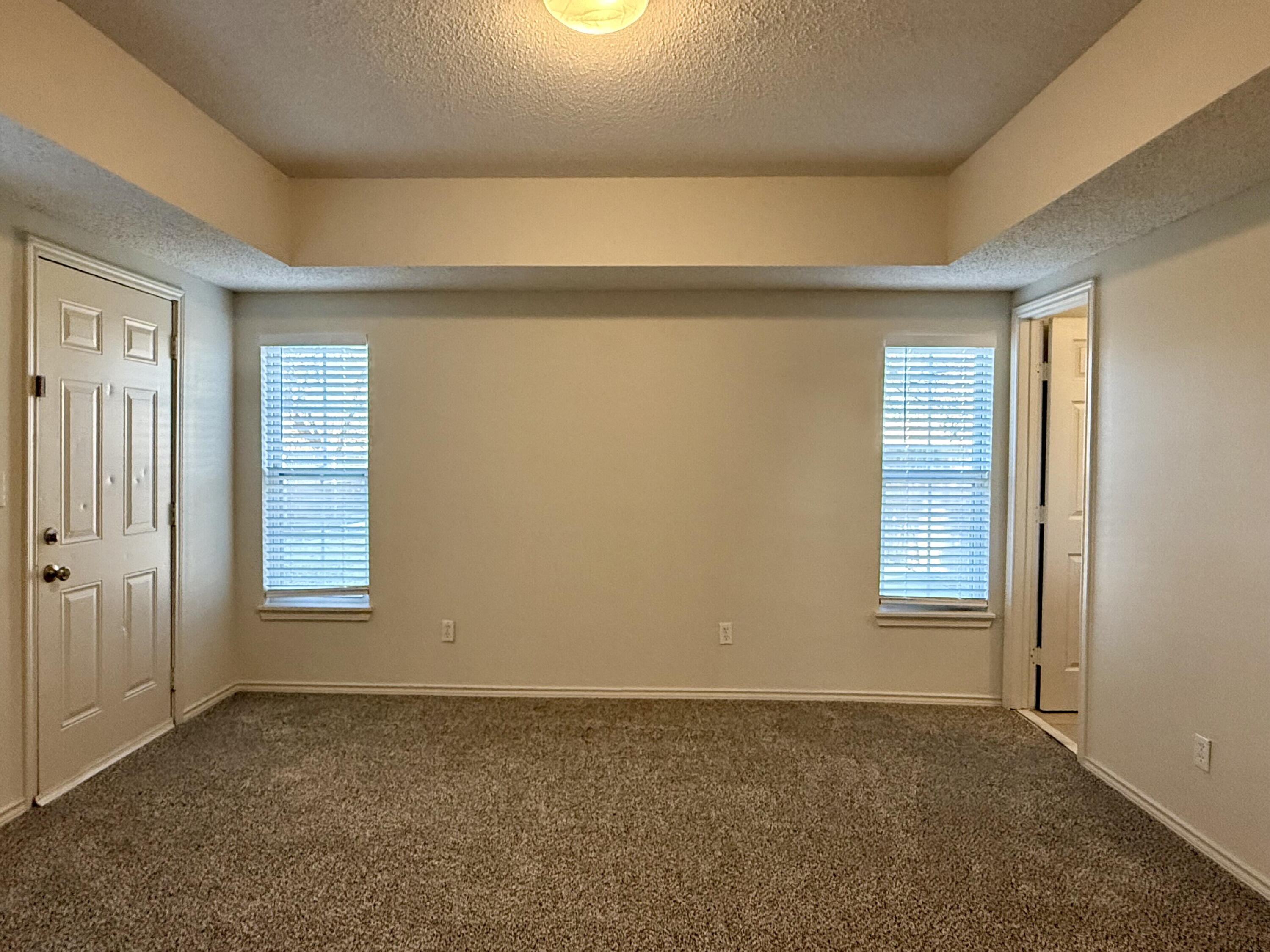 3607 Gary Avenue Lubbock, TX 79413 - Photo 8 of 26 an empty room with windows