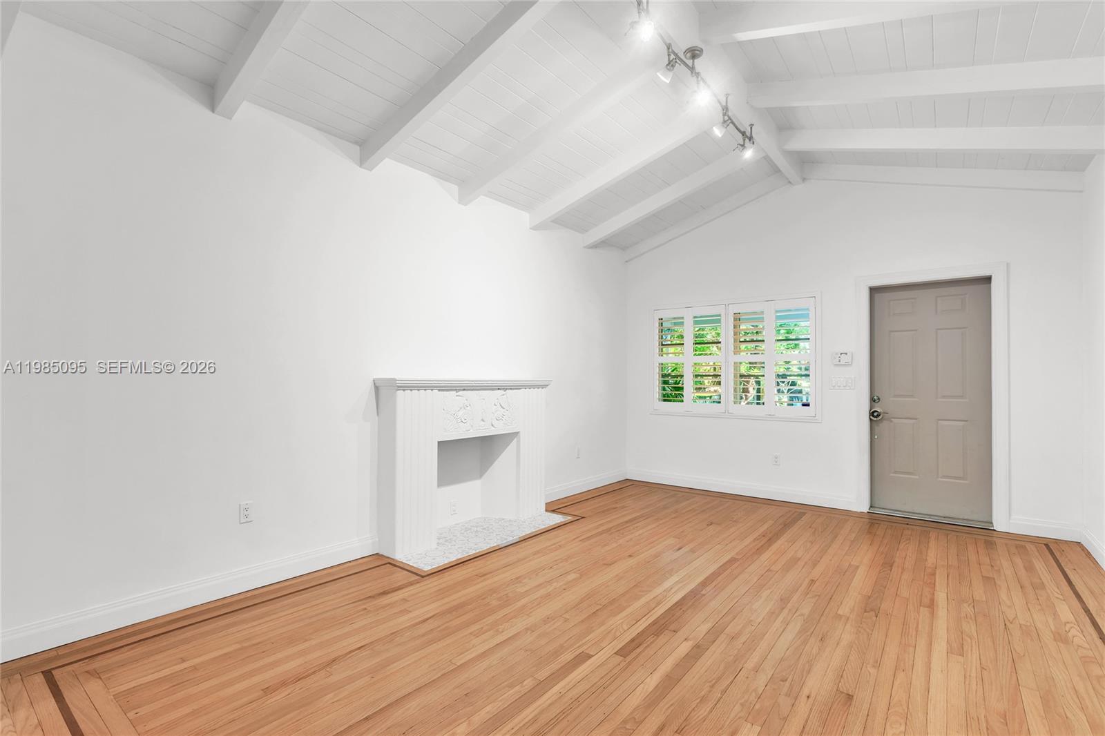 776 Northeast 74th Street Miami, FL 33138 - Photo 2 of 40 an empty room with wooden floor cabinet and windows