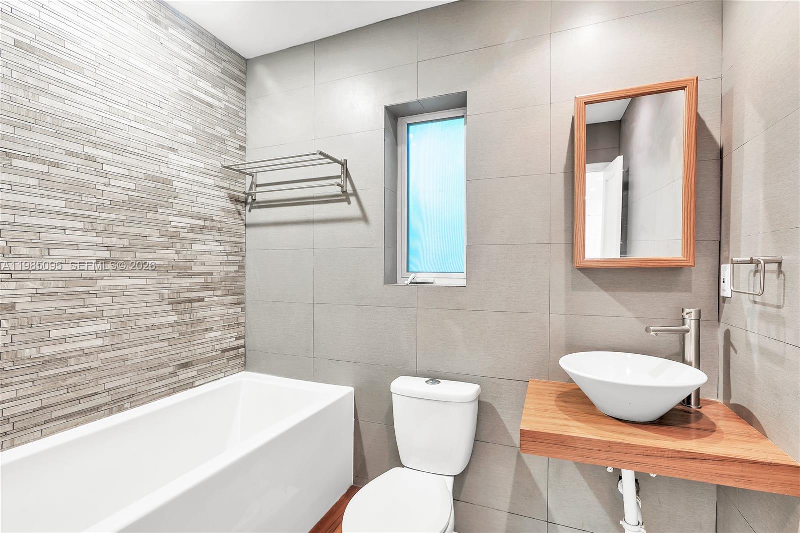 776 Northeast 74th Street Miami, FL 33138 - Photo 22 of 40 a bathroom with a toilet a sink and bathtub