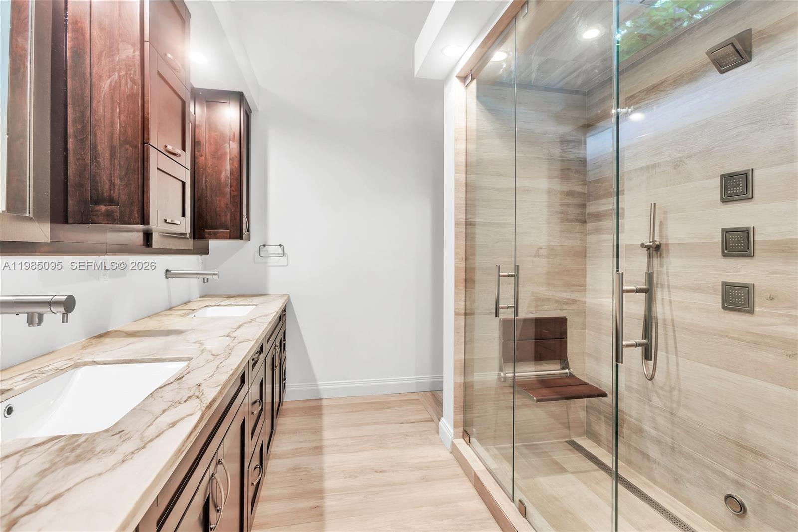 776 Northeast 74th Street Miami, FL 33138 - Photo 28 of 40 a bathroom with a granite countertop sink a mirror and shower