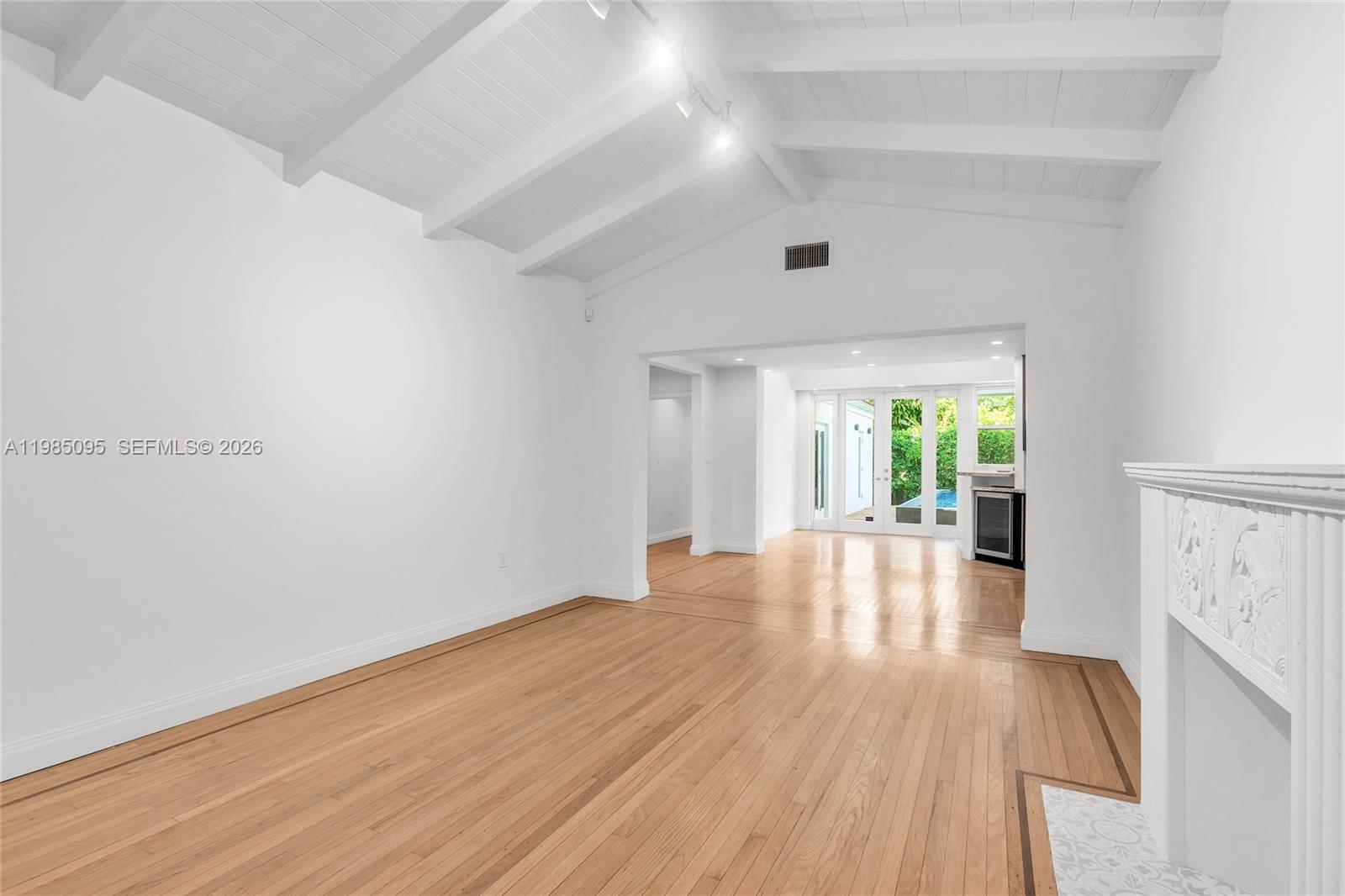 776 Northeast 74th Street Miami, FL 33138 - Photo 3 of 40 a view of empty room with wooden floor and fan