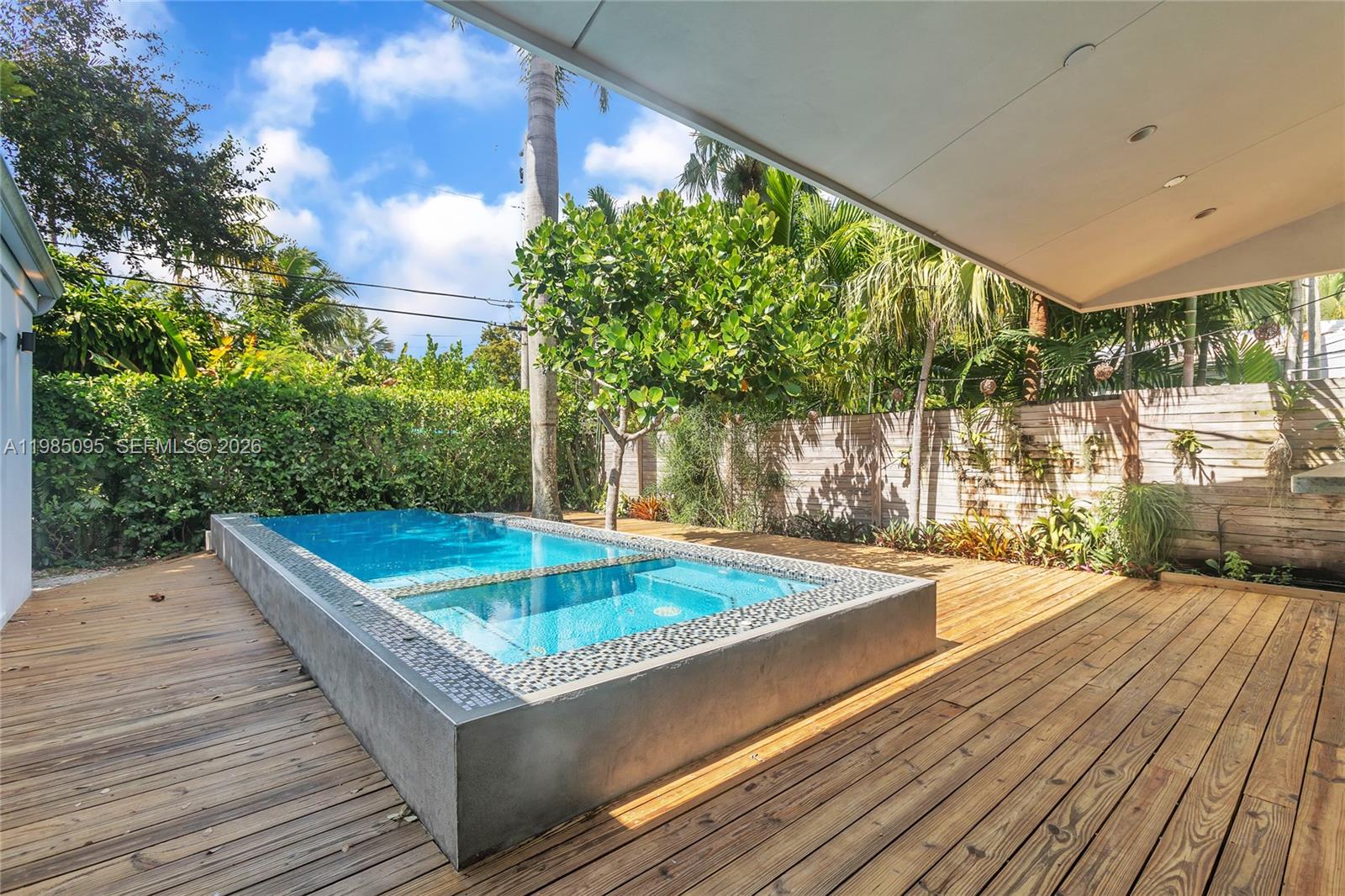 776 Northeast 74th Street Miami, FL 33138 - Photo 31 of 40 a view of a balcony with floor to ceiling windows with wooden floor