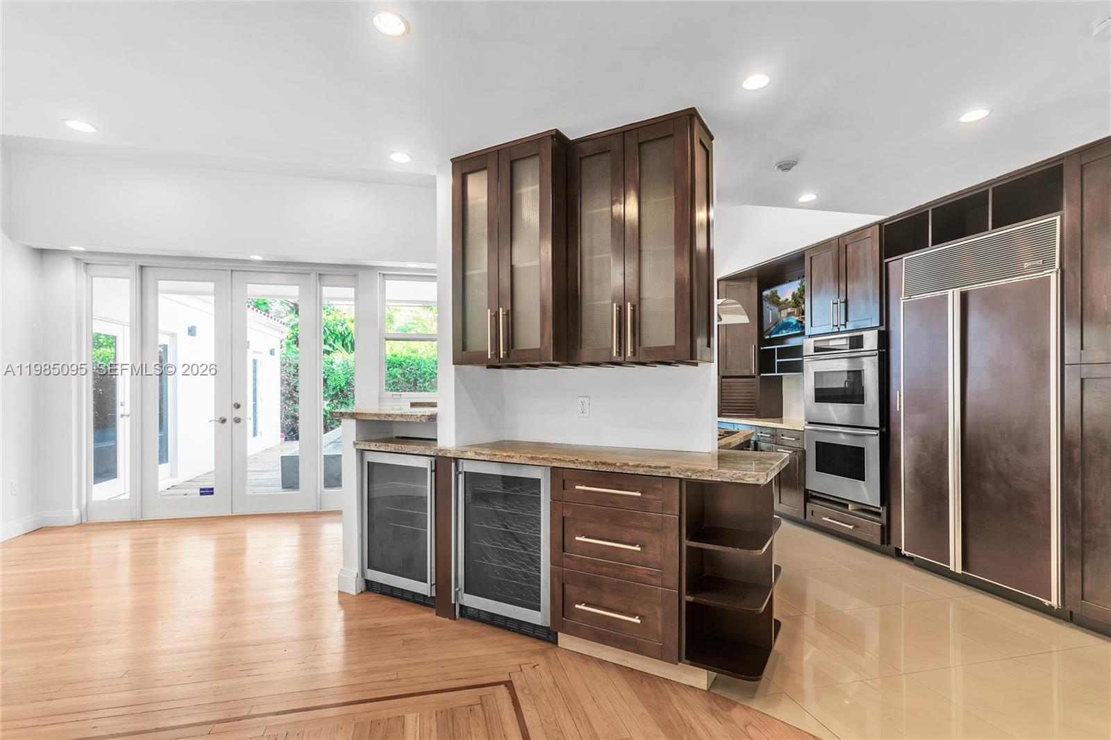 776 Northeast 74th Street Miami, FL 33138 - Photo 4 of 40 a kitchen with stainless steel appliances granite countertop a refrigerator and a stove top oven