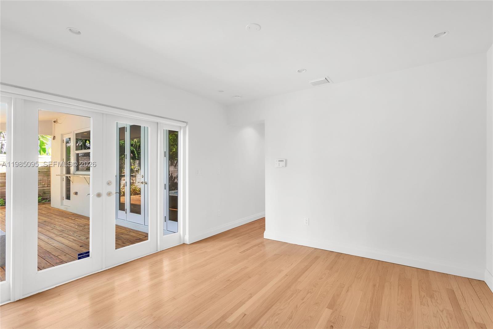 776 Northeast 74th Street Miami, FL 33138 - Photo 5 of 40 a view of an empty room with glass door