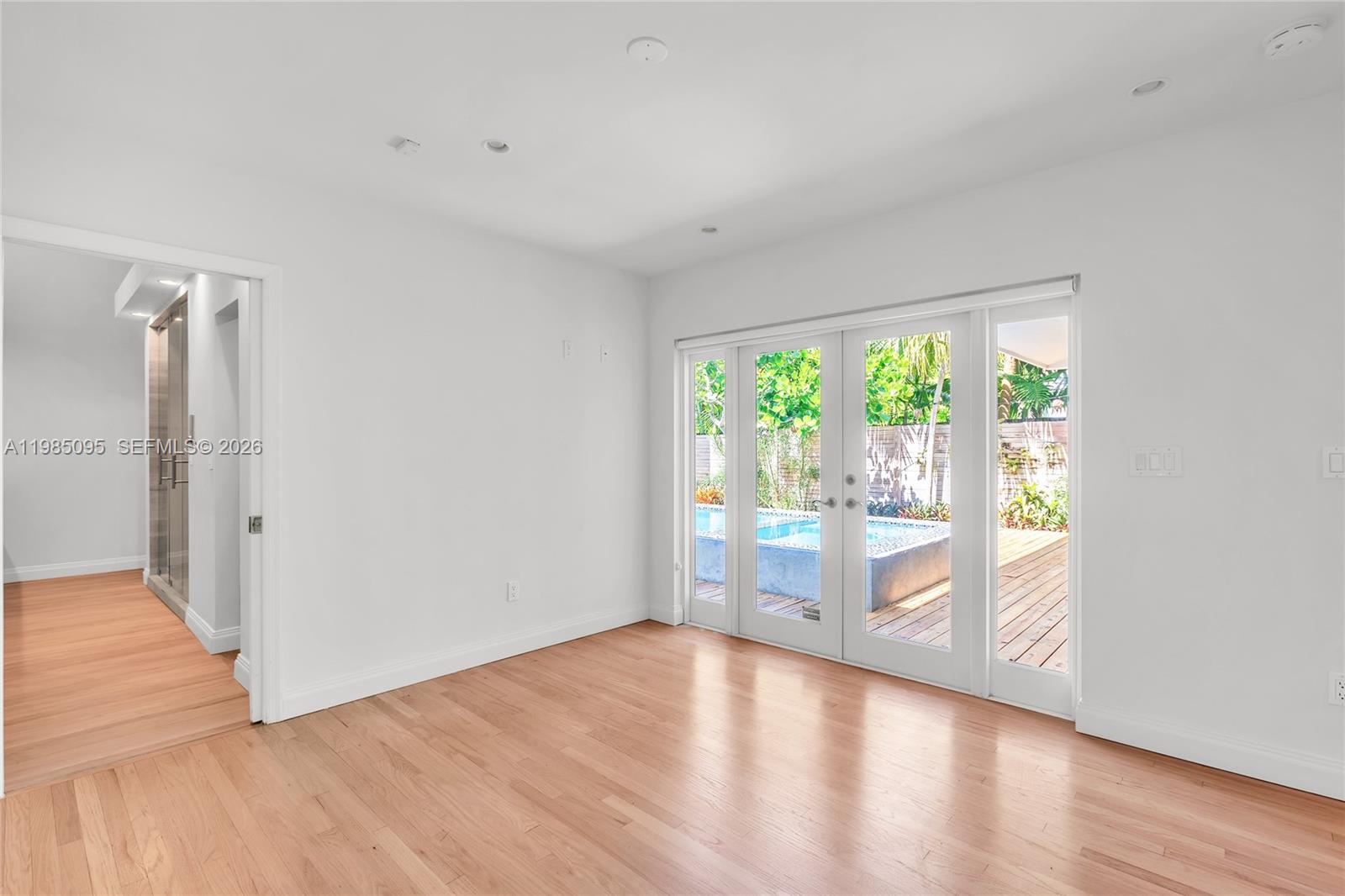 776 Northeast 74th Street Miami, FL 33138 - Photo 6 of 40 wooden floor in an empty room with a window