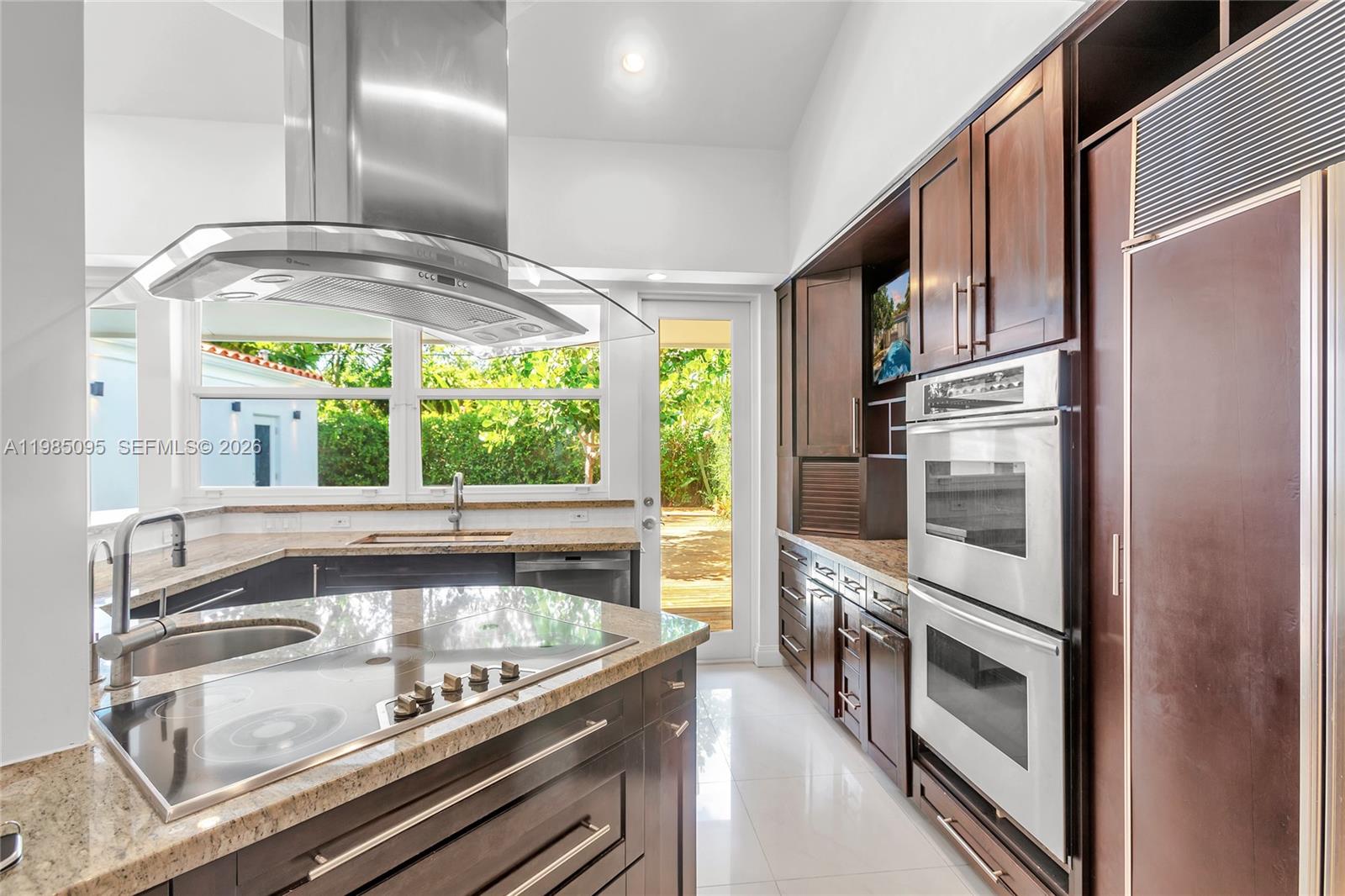776 Northeast 74th Street Miami, FL 33138 - Photo 10 of 40 a kitchen with stainless steel appliances granite countertop a stove and a refrigerator
