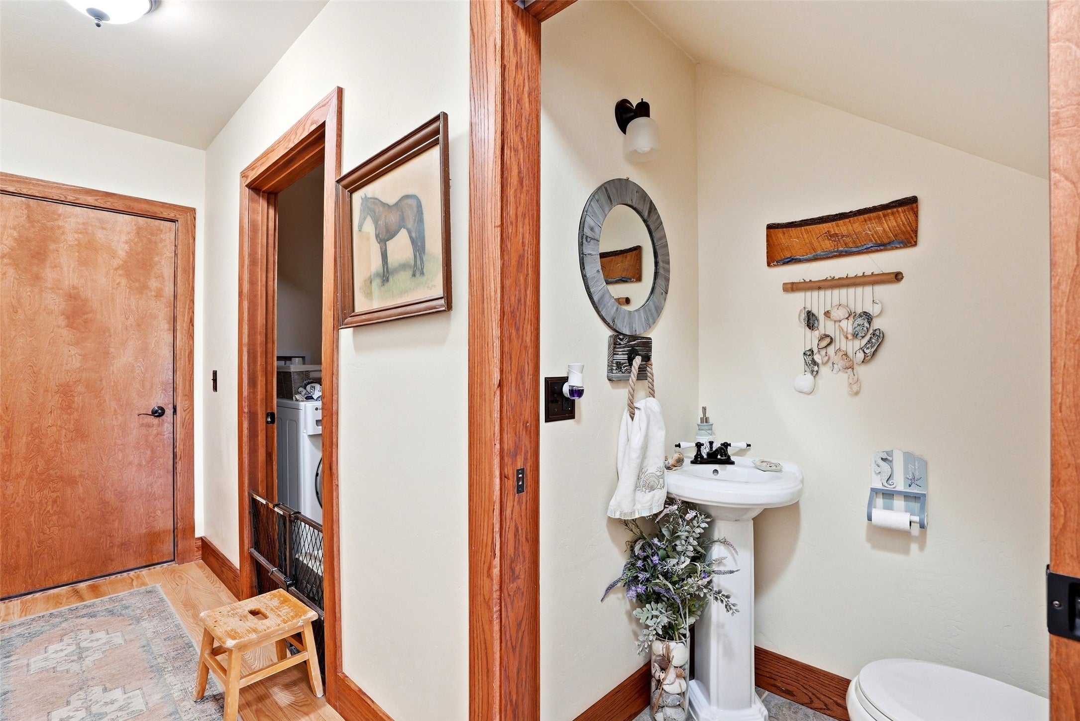 679 Hidden Valley Road North Florence, MT 59833 - Photo 36 of 85 Pedestal sink with a round framed mirror, light wood-finish trim, and a built-in laundry area with appliances