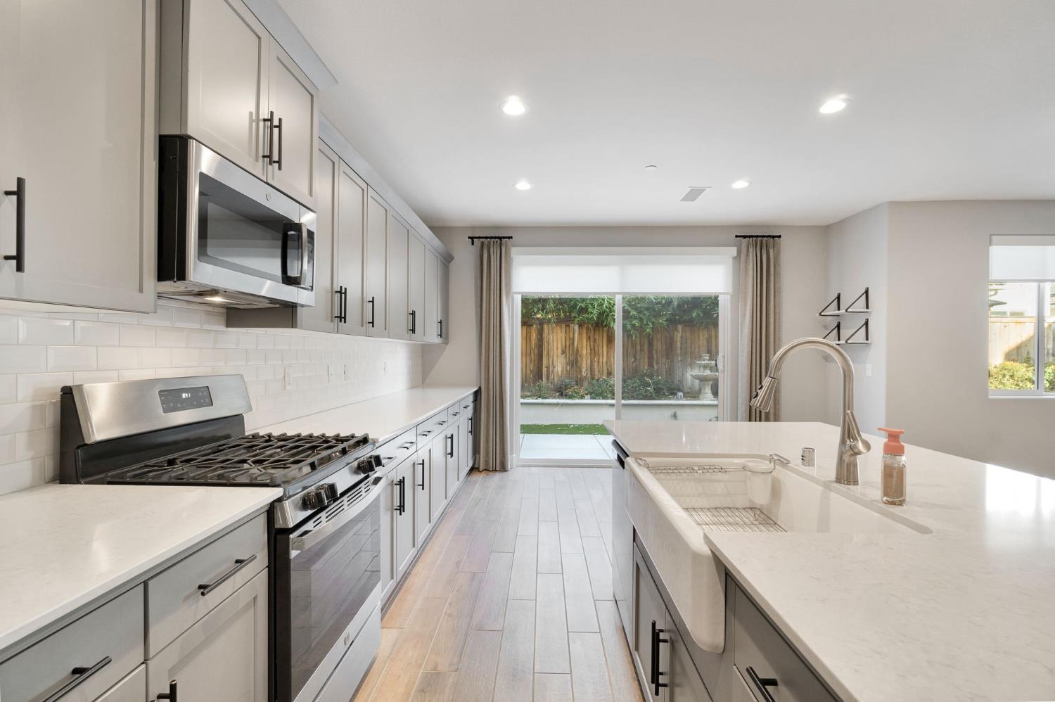 4415 Horizon Drive Madera, CA 93636 - Photo 15 of 41 a kitchen with stainless steel appliances granite countertop a sink stove and cabinets