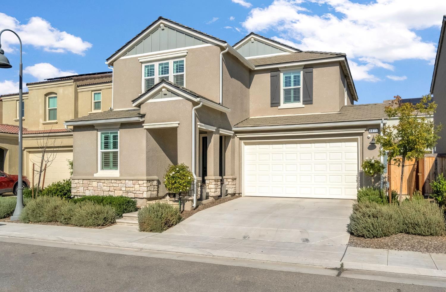 4415 Horizon Drive Madera, CA 93636 - Photo 2 of 41 a front view of a house with a yard and garage