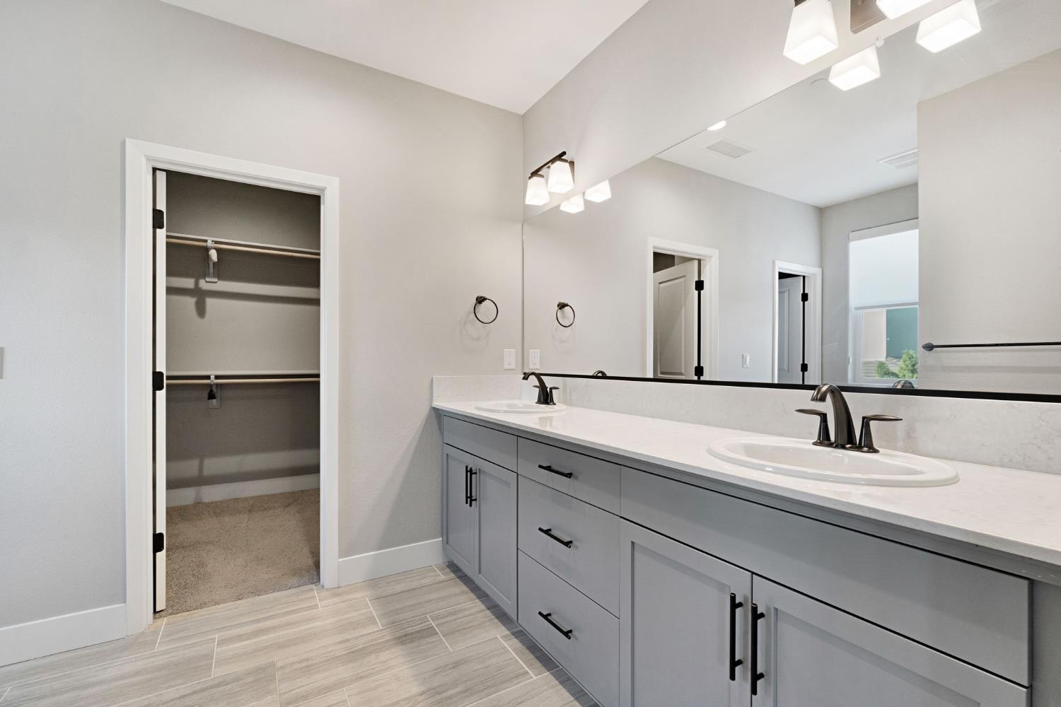 4415 Horizon Drive Madera, CA 93636 - Photo 32 of 41 a spacious bathroom with a double vanity sink and a mirror