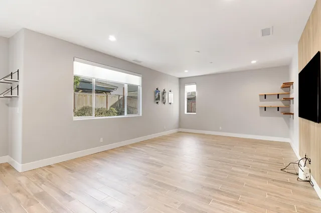 wooden floor in an empty room with a window