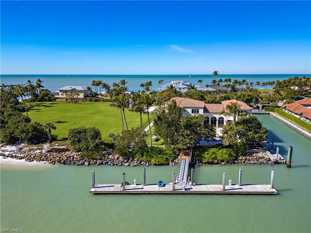 100 Bay Road Naples, FL 34102 - Photo 11 of 12 Bird's eye view of a nearby body of water and a forest