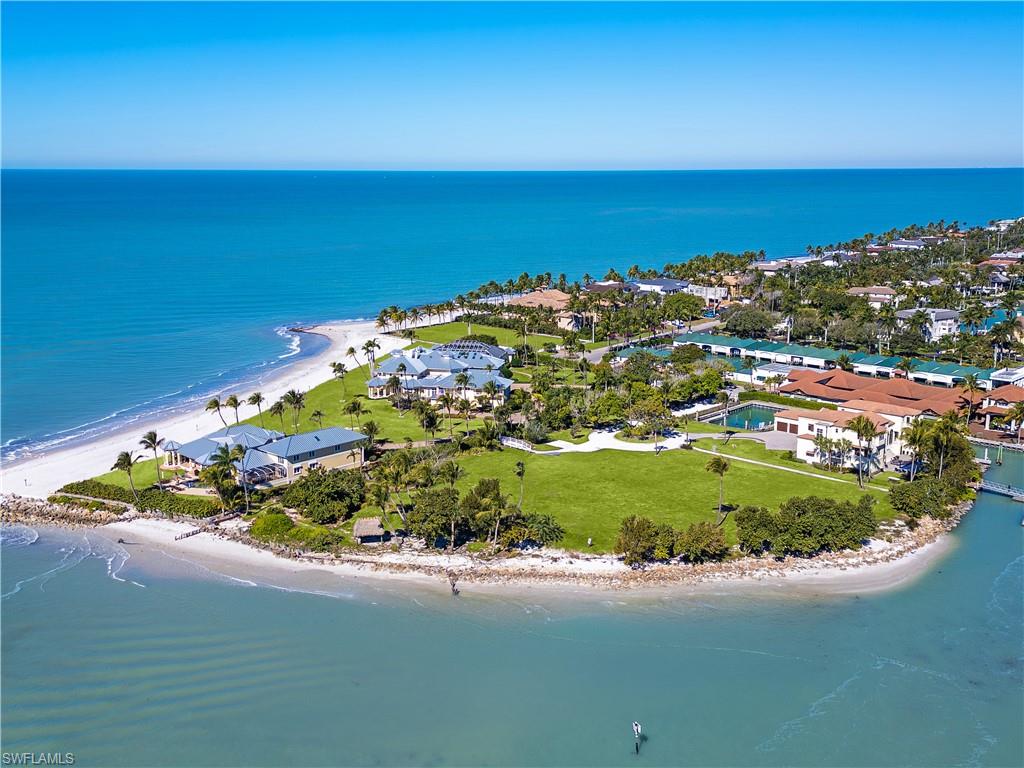 100 Bay Road Naples, FL 34102 - Photo 2 of 12 Drone / aerial view of waterfront with a beach