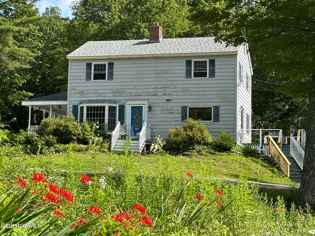 a kitchen with a granite countertop sink and wooden floor