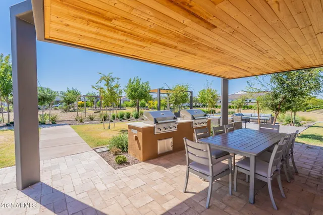 a view of a patio with a table and chairs under an umbrella