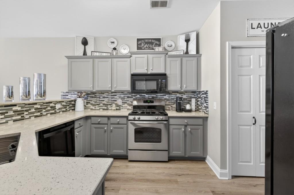 160 Riley Circle Dawsonville, GA 30534 - Photo 11 of 52 a kitchen with stainless steel appliances granite countertop a stove and a sink