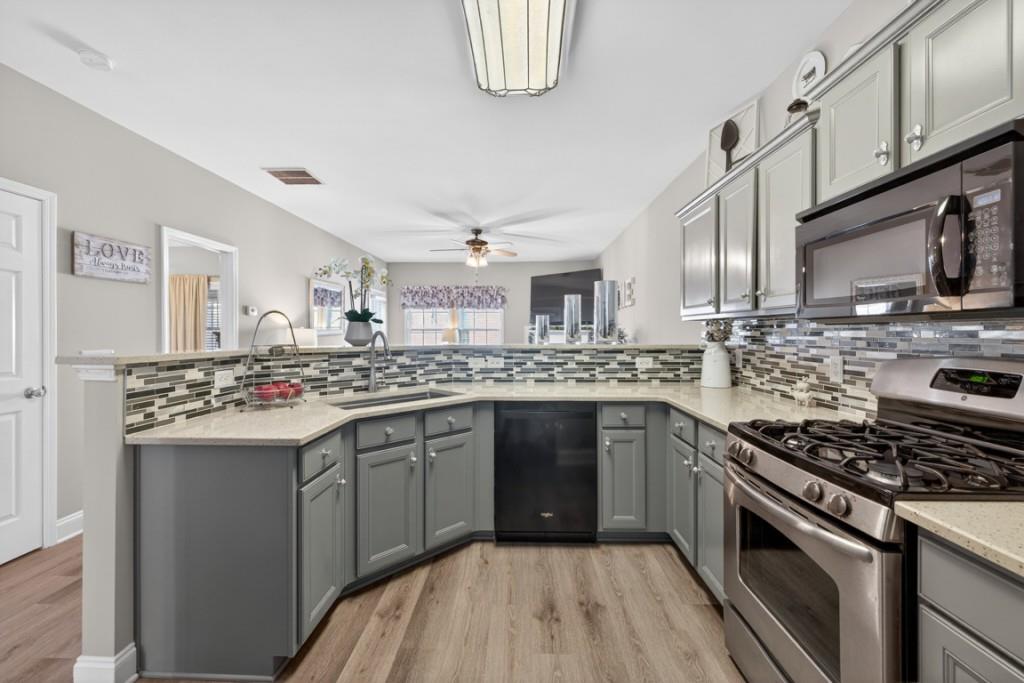 160 Riley Circle Dawsonville, GA 30534 - Photo 12 of 52 a kitchen with stainless steel appliances a sink stove and cabinets