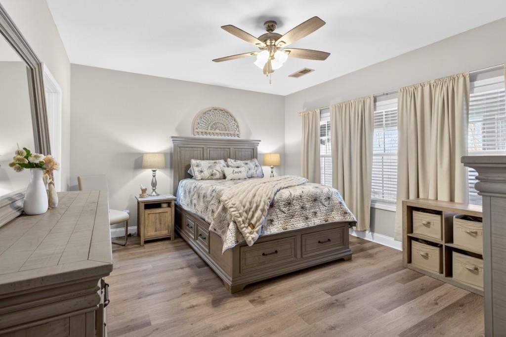 160 Riley Circle Dawsonville, GA 30534 - Photo 16 of 52 a bedroom with a large bed a chandelier and windows