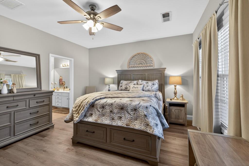 160 Riley Circle Dawsonville, GA 30534 - Photo 17 of 52 a bedroom with a bed and a chandelier