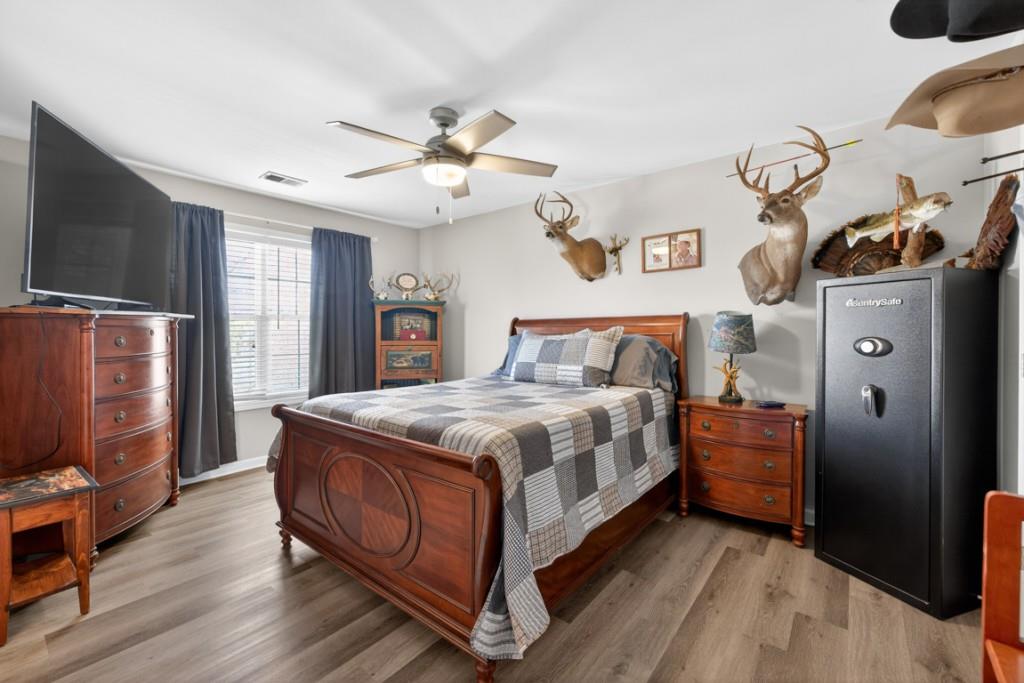 160 Riley Circle Dawsonville, GA 30534 - Photo 30 of 52 a bedroom with a bed and a flat tv screen on the dresser