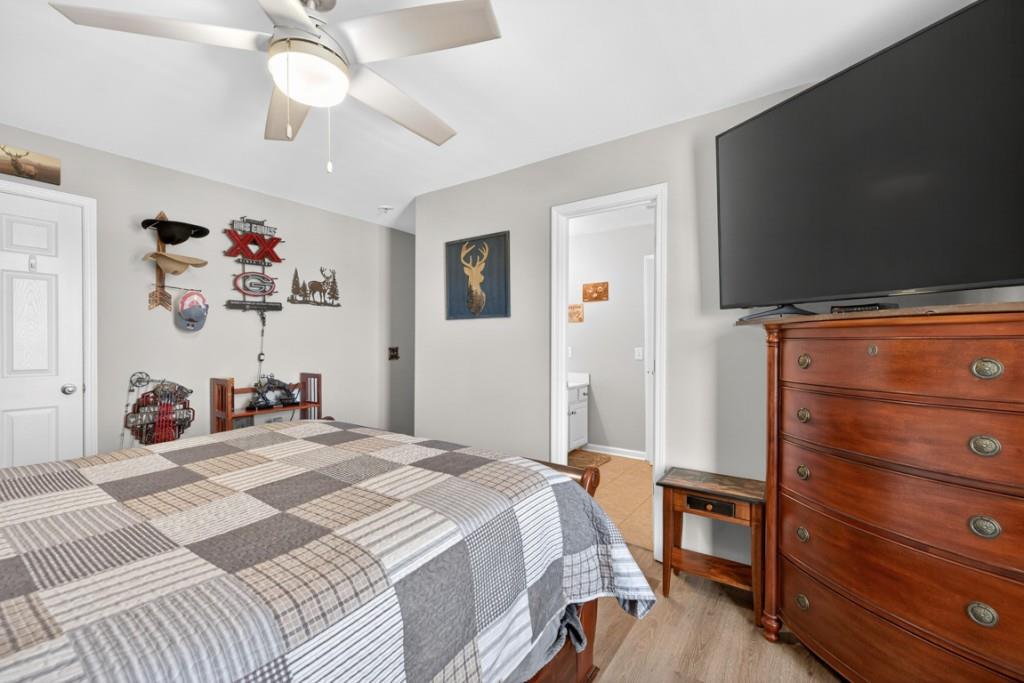 160 Riley Circle Dawsonville, GA 30534 - Photo 31 of 52 a bedroom with a bed and a chandelier