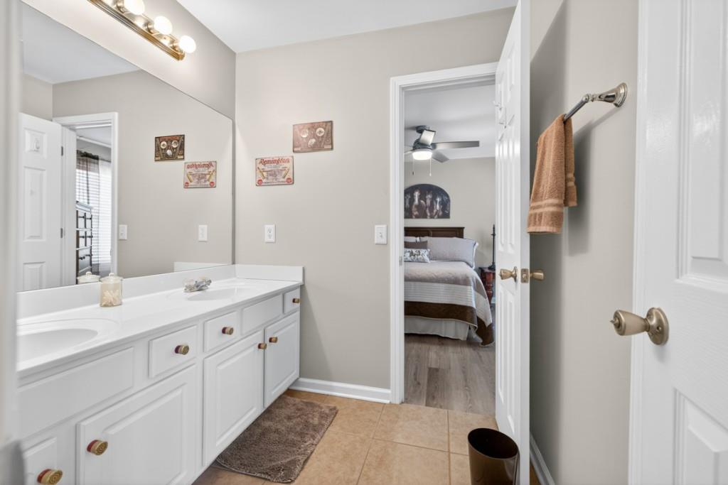 160 Riley Circle Dawsonville, GA 30534 - Photo 32 of 52 a en suite bathroom with a granite countertop sink and a mirror