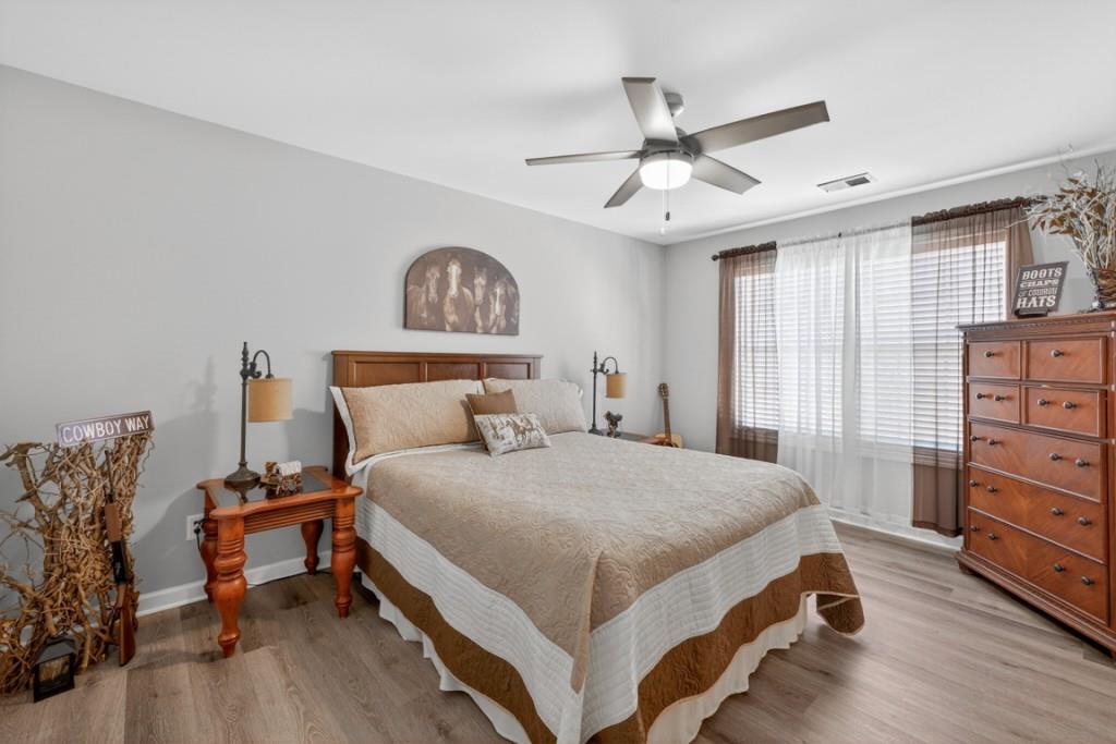 160 Riley Circle Dawsonville, GA 30534 - Photo 35 of 52 a bedroom with a bed and a chandelier