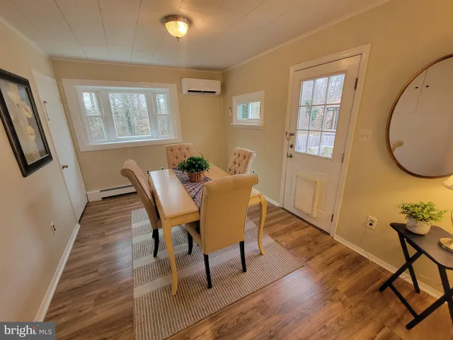 a view of a dining room with furniture window and wooden floor
