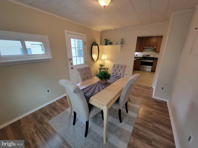 a view of a dining room with furniture and window