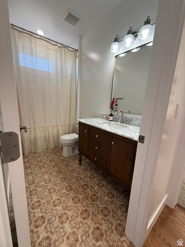 3550 North River Ln Road East Panguitch, UT 84759 - Photo 7 of 25 Bathroom featuring a single vanity with a dark wood-finish cabinet, a light-toned countertop, and a rectangular mirror