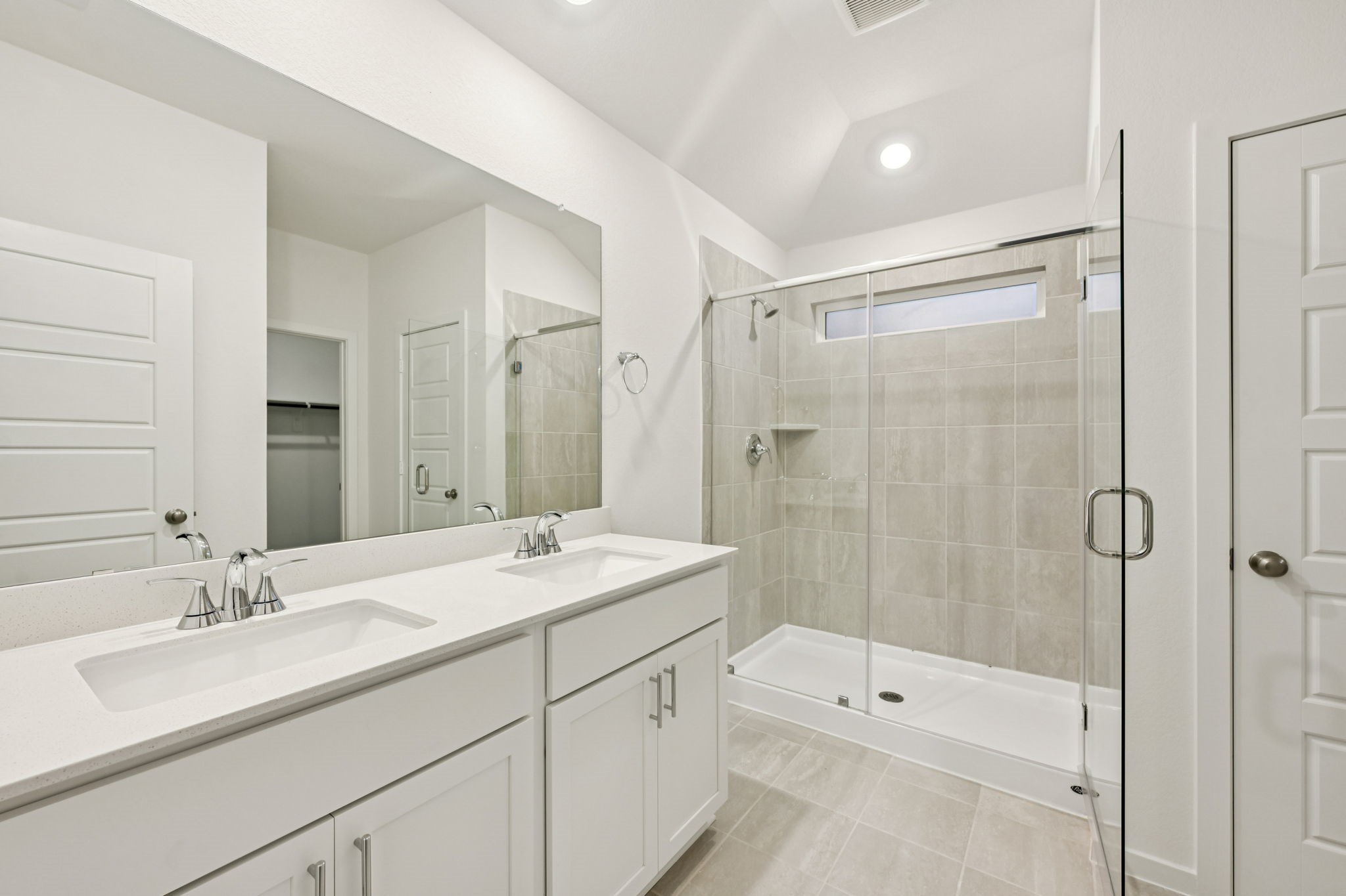16213 Parish Pointe Court Conroe, TX 77302 - Photo 23 of 32 a bathroom with a shower tub double vanity sink and mirror