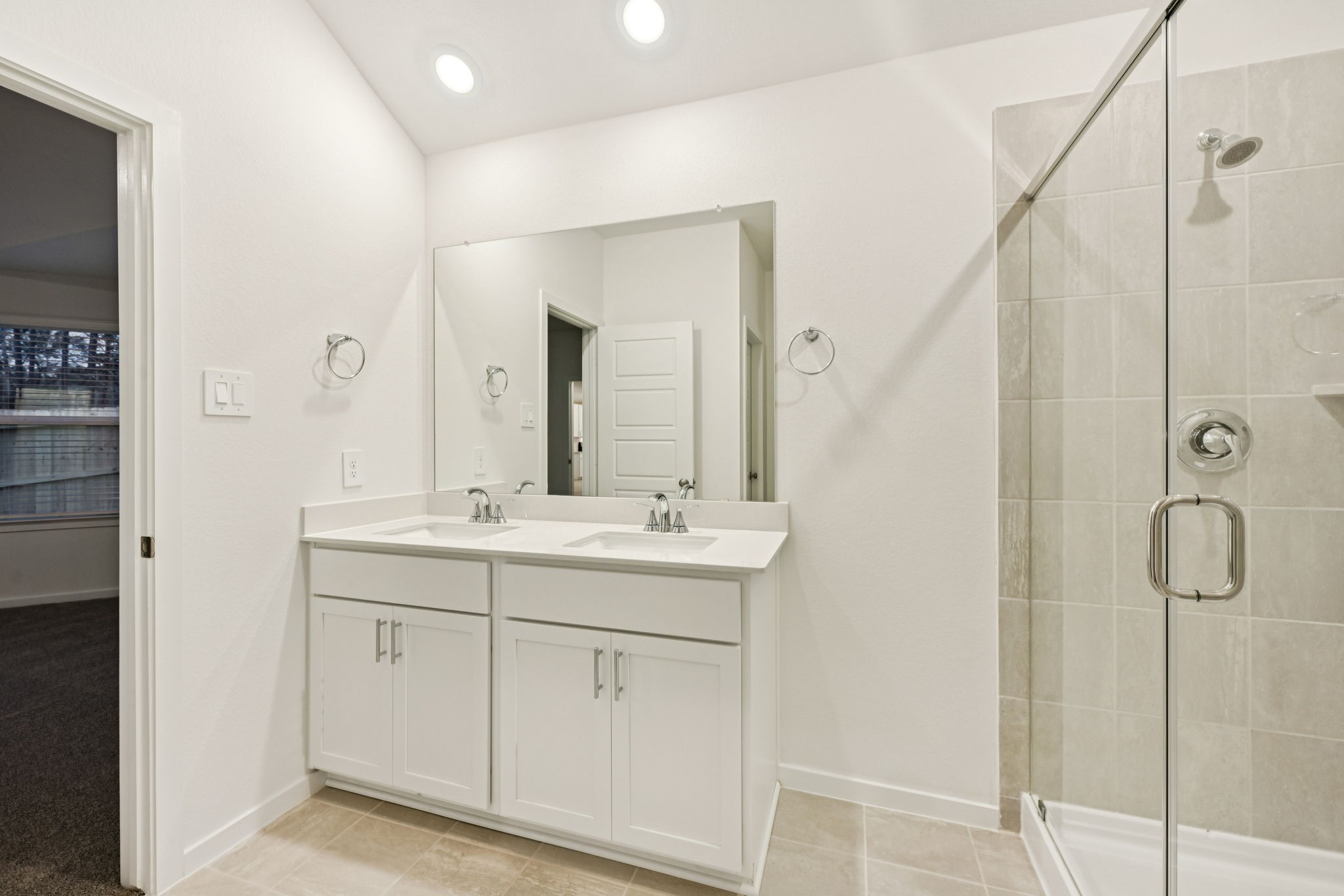 16213 Parish Pointe Court Conroe, TX 77302 - Photo 24 of 32 a bathroom with a double vanity sink and mirror